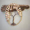 jute wrapped hoop with brown wire tree of life attached various tones of sand, cream, and beige color wood beads adorn branches